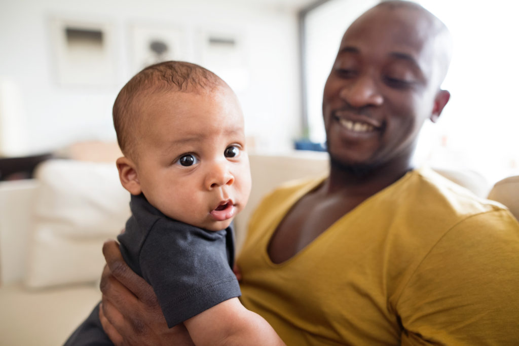 a man holding his baby son